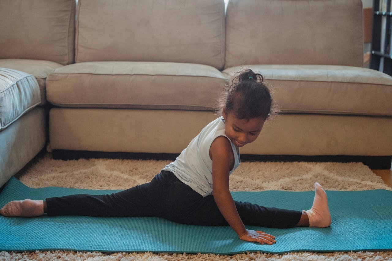 Focused girl doing leg split